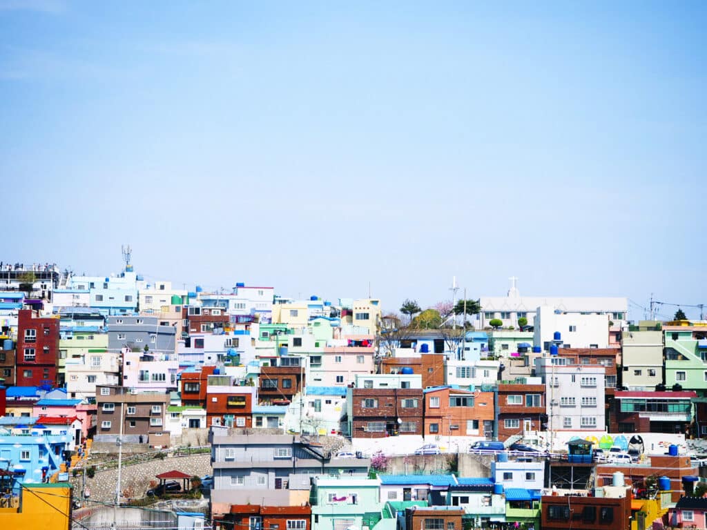 The most famous colourful houses in Busan, South Korea, under a sunny sky.