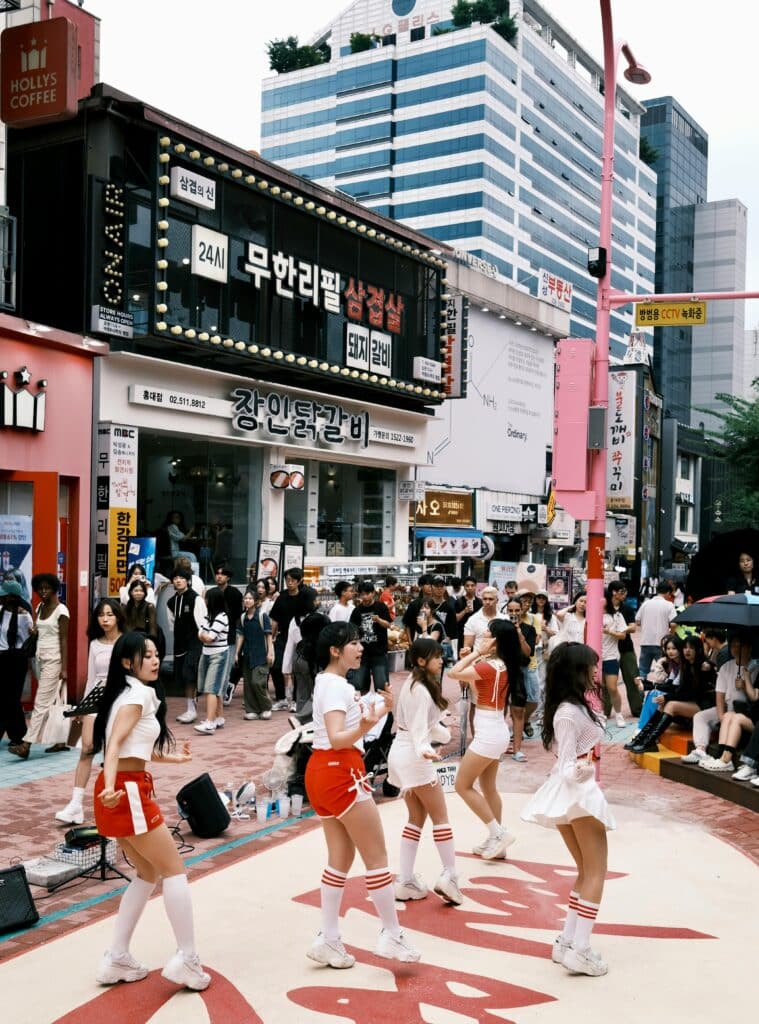 A group of young girls perform in a trendy district of Seoul.