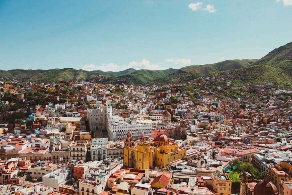 View of the colorful city of Guanajuato, City, surrounded by green mountains and under a summer sky.