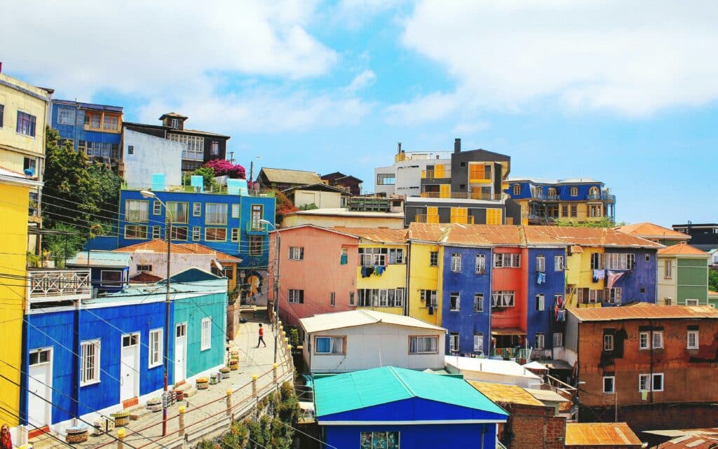 Colourful roofs of Chilean houses in the city of Valparaiso. The houses are located high up on a hillside.