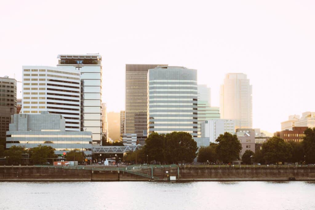 Photo of the Vera katz eastbank esplanade in Portland in the United States, with little colour contrast. You can see tall buildings along a stretch of water.