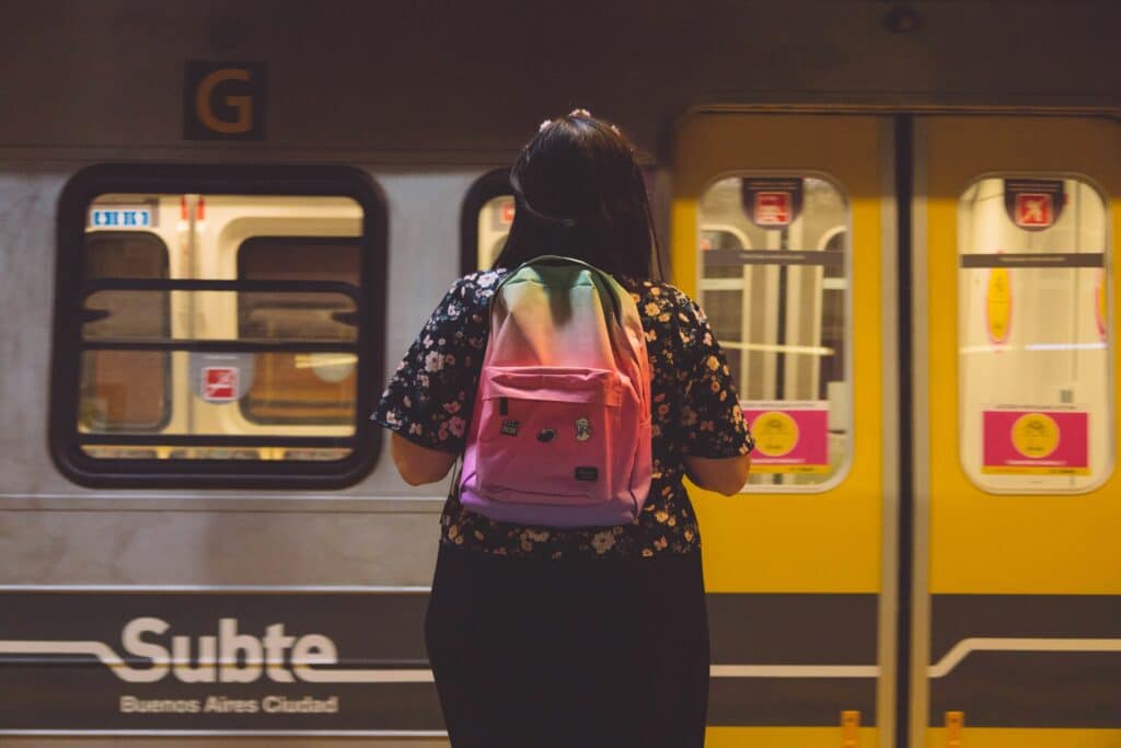 A woman wearing a colourful rucksack waits in the underground metro in Buenos Aires, Argentina.